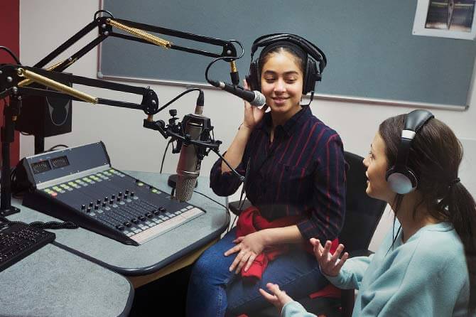 Two women discussing on air (in radio) the advantages of the
