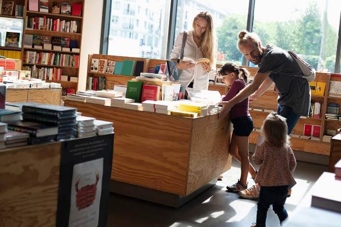 Family with two daughters looking for interesting NetSuite books in the bookshop.