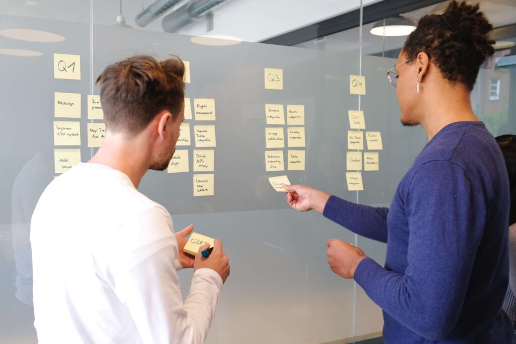Project planning using post-it notes on glass board